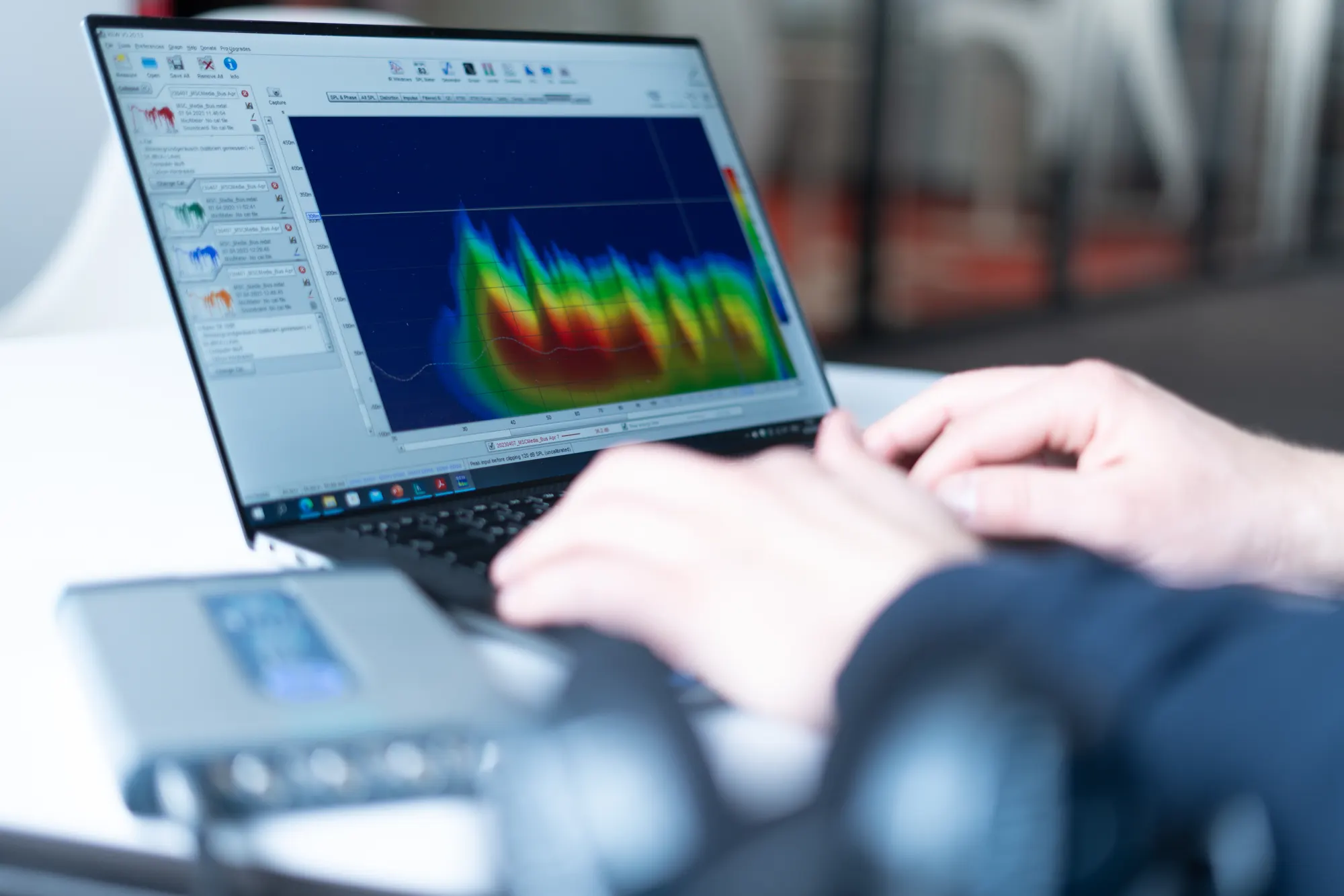 Evaluating a measurement on a laptop: a spectrogram, with the measurement system in front.